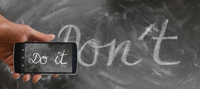 Cursive words on chalkboard, "Don't"; and "Do it" on a phone screen.