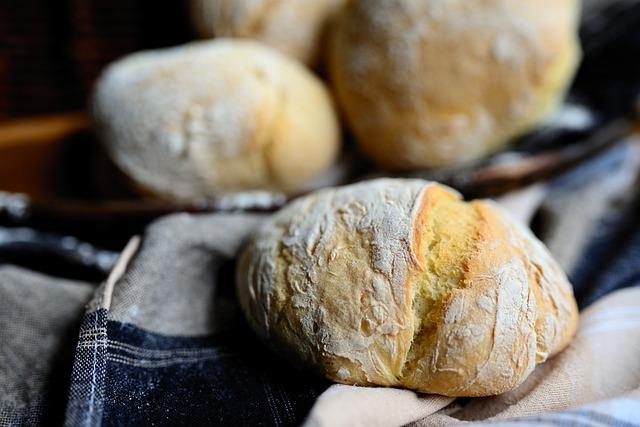 Three yeast rolls, one in focus, two blurry in the background.