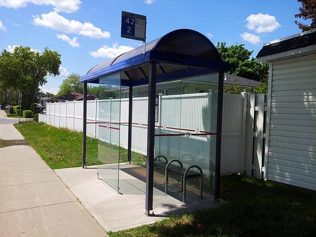 An empty, clean bus stop with no bus.