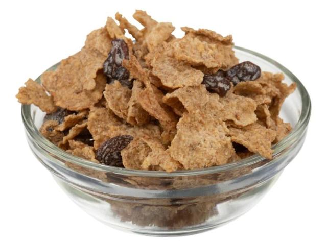 A clear glass bowl filled with bran cereal with raisins.