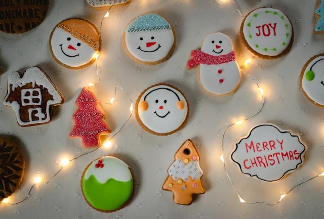 An assortment of decorated Christmas cookies spread out so each one is clearly visible.