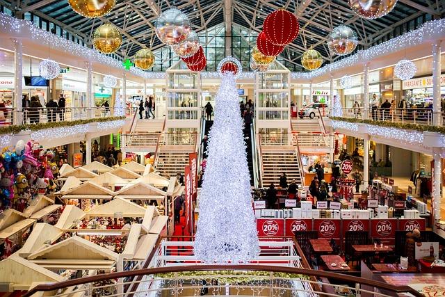 The inside of a large shopping mall decorated for Christmas.