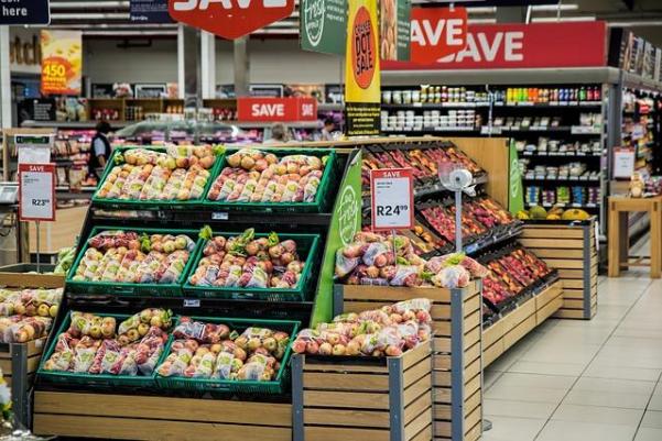 the produce section of a grocery store with dry goods visible behind.