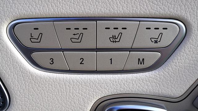 The console of a Mercedes showing the buttons for heated seats.