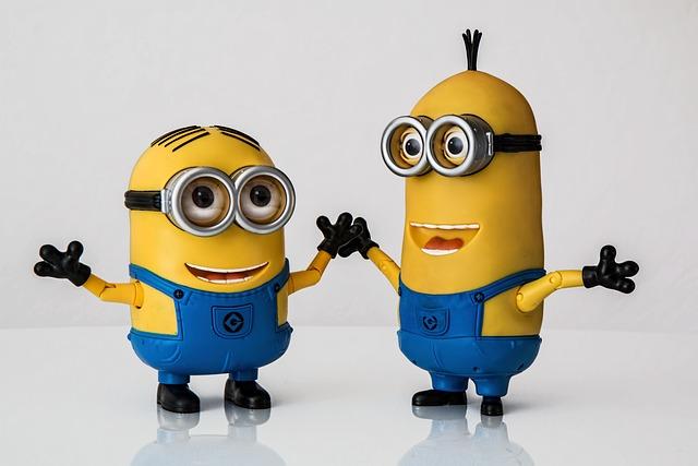 Two minions, one short, one taller with their arms raised.