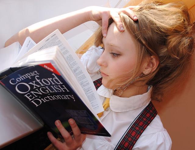 A school-aged girl reading the Oxford English Dictionary