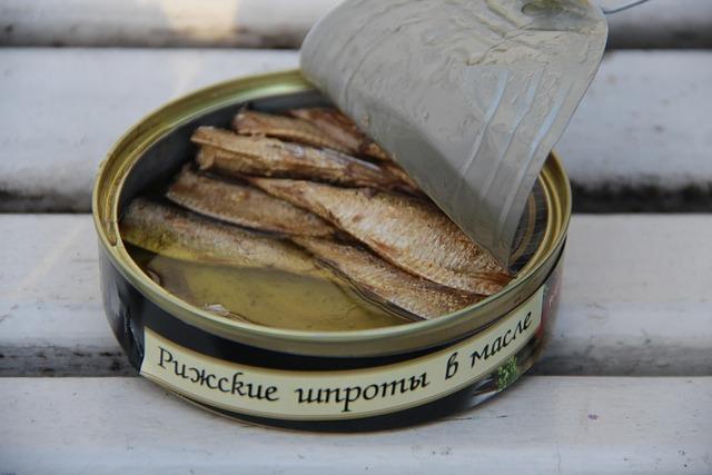 A can of sardines with the lid pulled back.