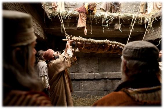 Paraplegic being lowered through the roof by his friends