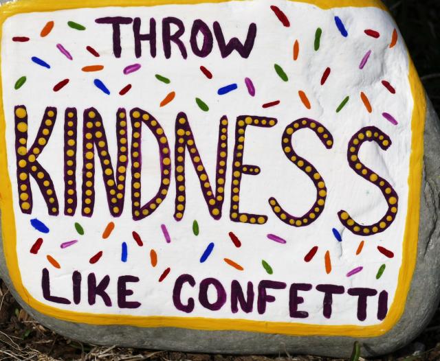 A rock painted with the message, "Throw kindness like confetti."