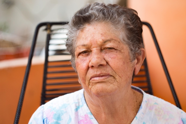 older woman with short grey hair looking directly at us