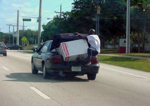 Funny Pictures of Guy Riding With Computer in Car Trunk