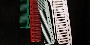 Several colored combs on a black background.