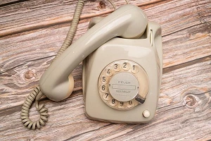 This is your Last and Final Warning A bone-colored vintage telephone, complete with rotary dial and spiral cord to the handset.