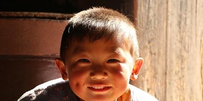 A young boy with an impish grin and dimples.
