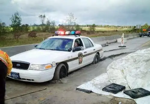 Funny Pictures of A Police Car Stuck In Cement