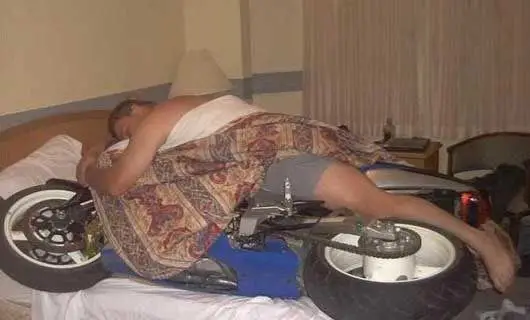 Funny Pictures of Man Sleeping With Motorcycle
