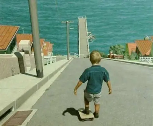 Funny Pictures of Kid With Skateboard on Hill