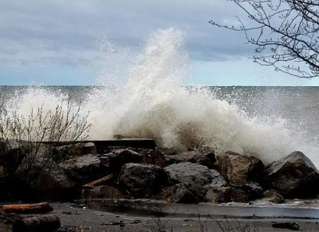 A wave crashing over a rocky outcropping near the shore of Lake Ontario.
