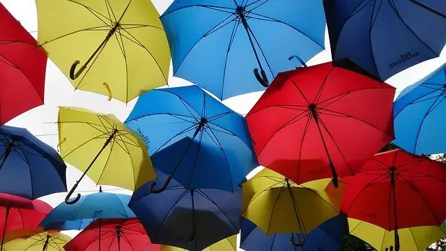 several colorful umbrellas floating in the sky