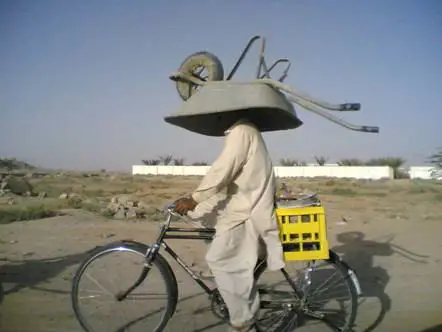 Funny Pictures of Bike Rider with Wheel Barrow on Head
