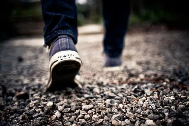 Feet in runners, walking away.