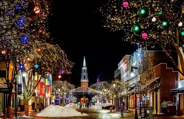 Looking down the main street of a small town all decked out and lit up for Christmas.
